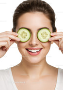 Happy Woman with Cucumber Slices Over Eyes for Skincare Relaxation