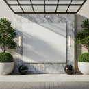 Modern outdoor wall with blank marble panel and greenery
