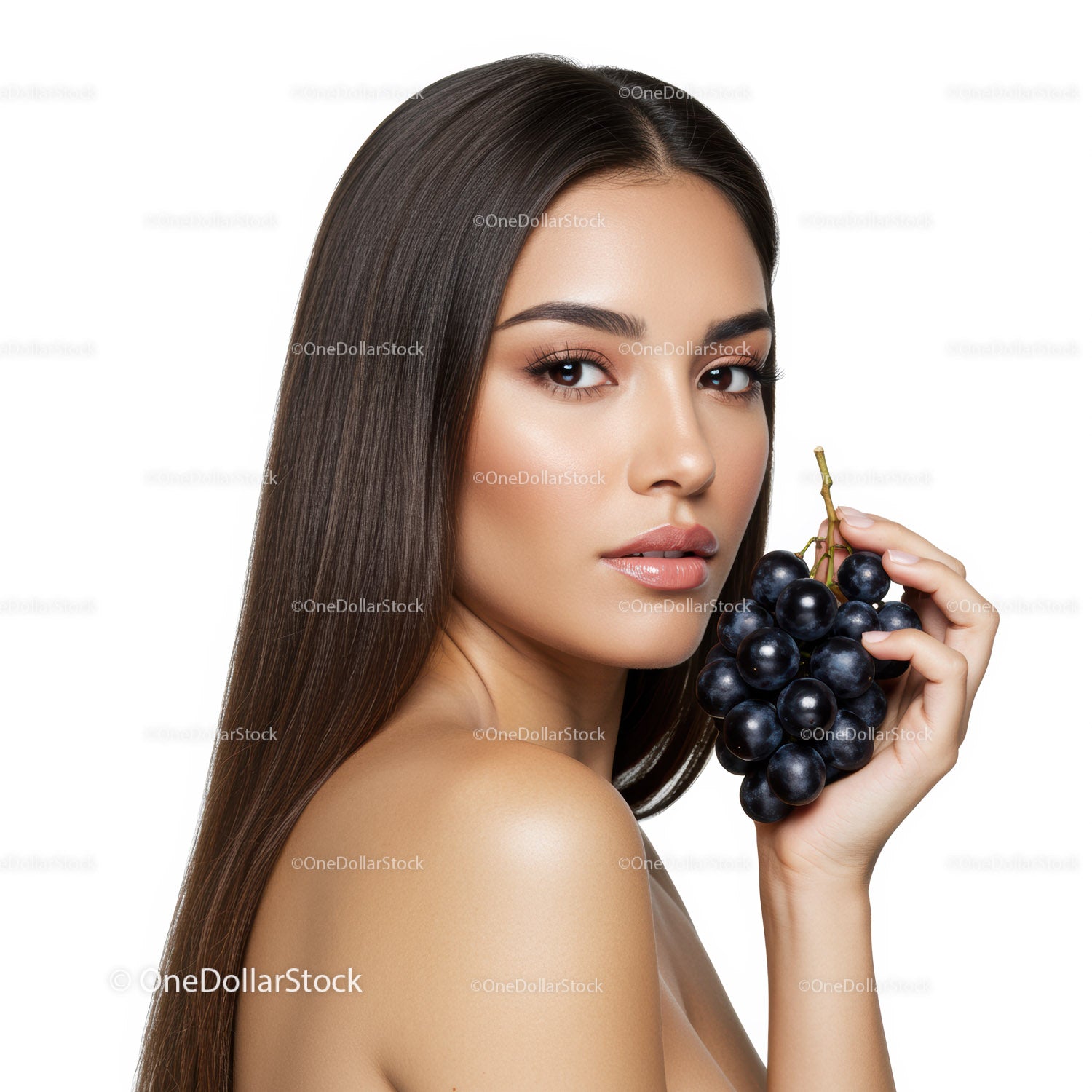 Elegant Woman with Long Brown Hair Holding Black Grapes in Studio