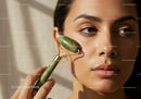 Close Up of Young Woman Using Jade Roller for Face Skin Care