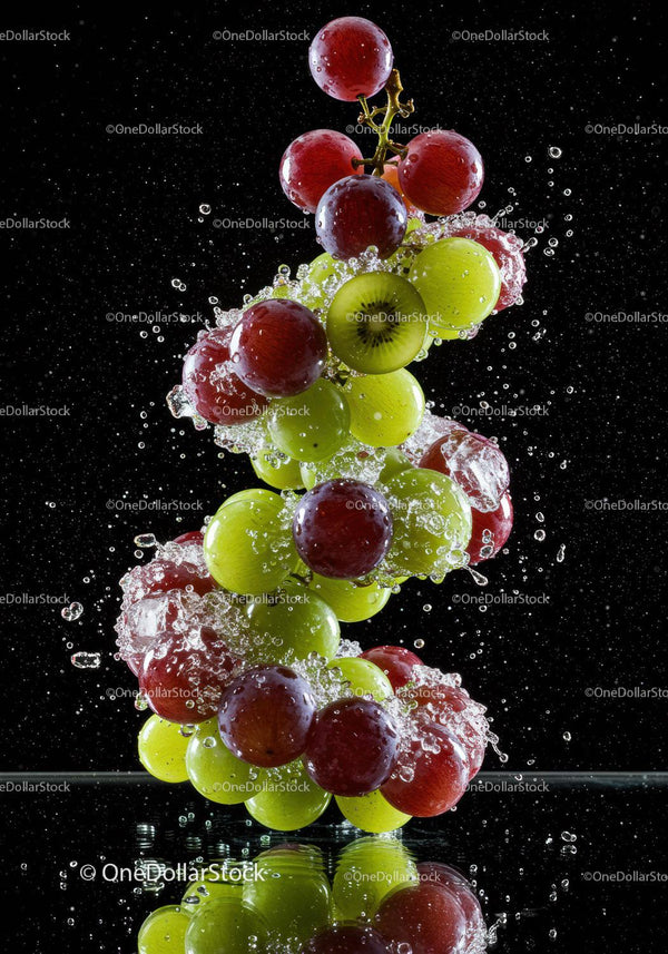 Fresh grapes and kiwi splashing in water with reflection