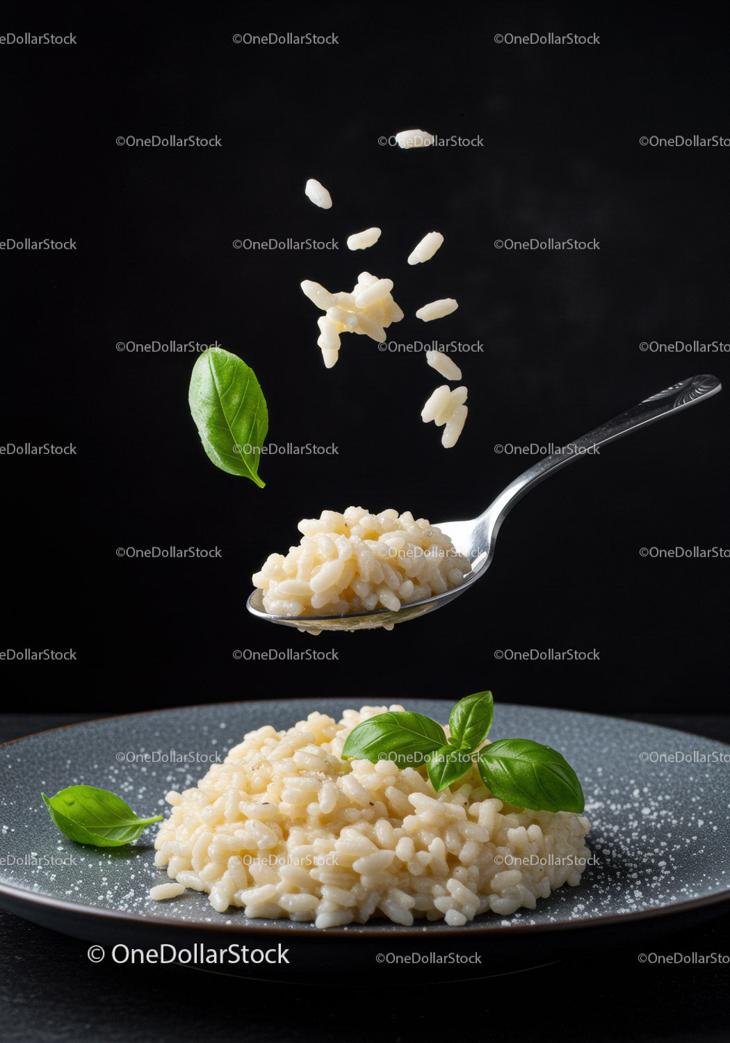 Creamy risotto served on plate with fresh basil leaves