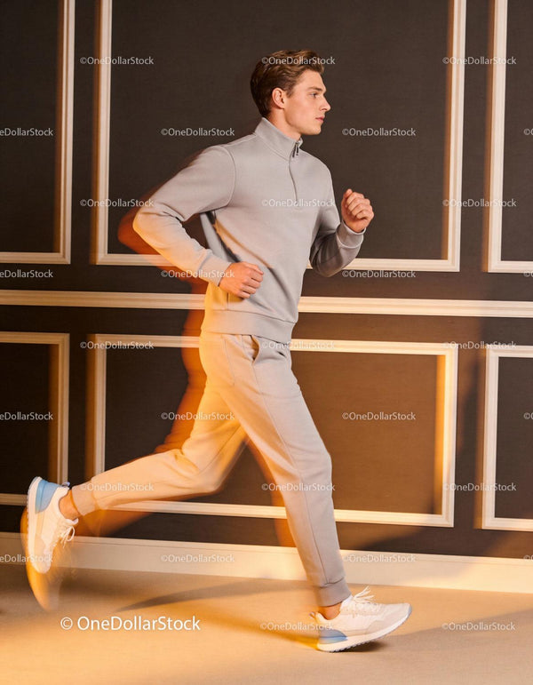 Young man jogging indoors in modern casual sportswear
