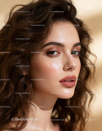 Close-up portrait of confident woman with glowing skin