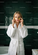 Woman in White Bathrobe Applying Eye Masks for Skincare Routine