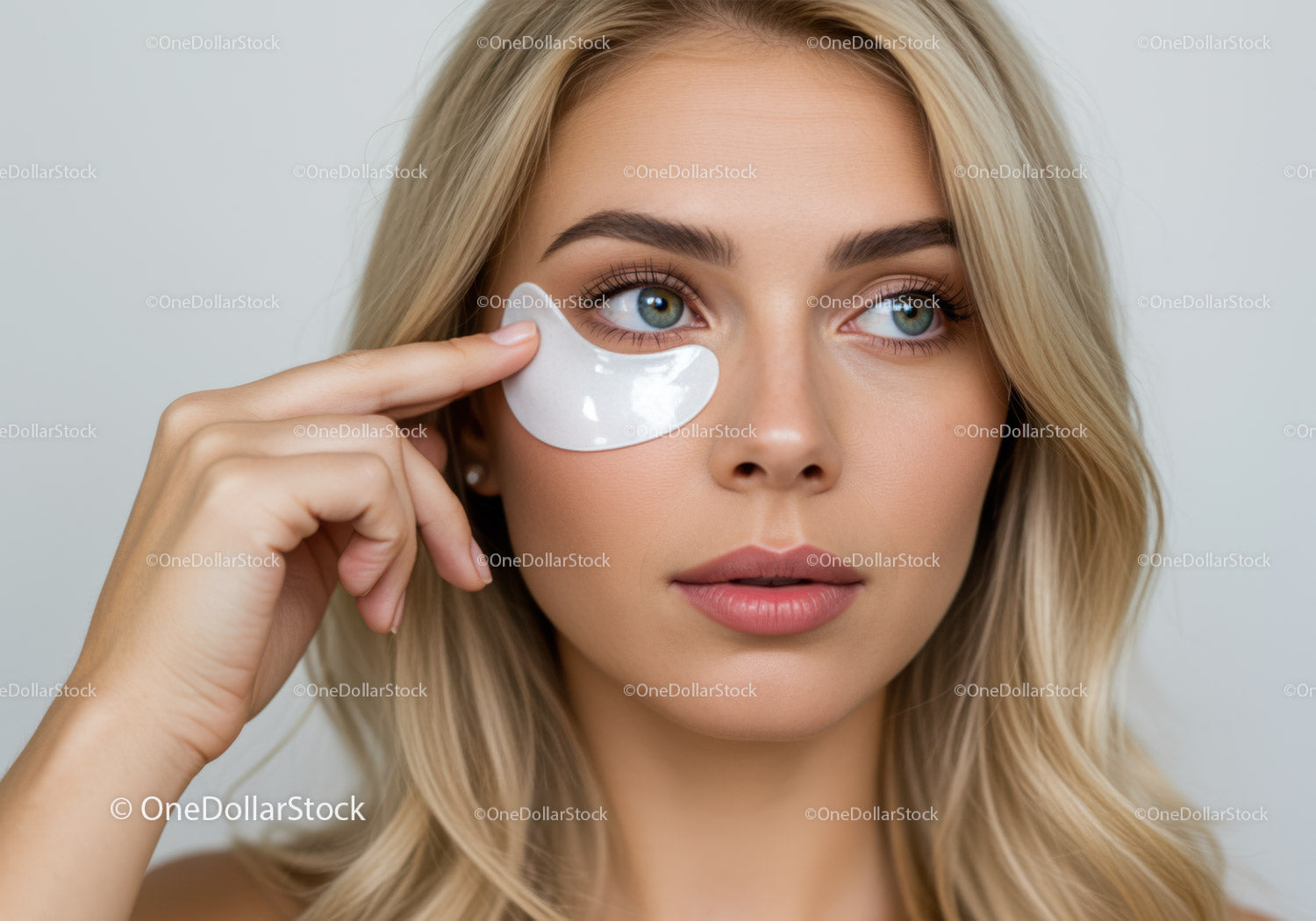 Young Woman Applying Under Eye Patch For Skin Refreshment