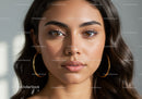 Close-up of a Beautiful Young Woman with Brown Eyes and Hoop Earrings