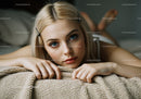 Close-Up Portrait of a Young Woman Relaxing on Cozy Blanket