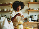Woman Preparing Banana Smoothie in Cozy Kitchen Setting
