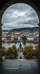 Colorful Waterfront Cityscape with River and Mountain Background