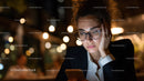 Young Woman Using Smartphone at Night in Urban Environment