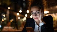 Young Woman Using Smartphone at Night in Urban Environment