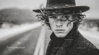 Stylish Young Man Wearing Fedora Hat in Black and White Portrait