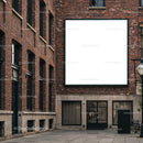 Empty white billboard on old red brick street building