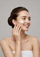 Beautiful Woman Applying Facial Cream for Skincare Routine