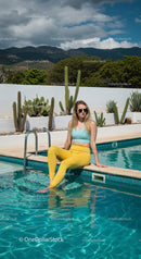 Trendy Young Woman Relaxing by the Vibrant Swimming Pool
