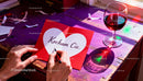 Handwriting a Valentine's card with romantic red wine glass