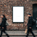 Urban street scene with blank advertising poster on brick wall