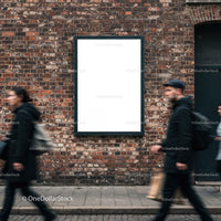 Urban street scene with blank advertising poster on brick wall
