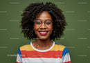 Portrait of a Smiling Woman with Curly Hair and Glasses in Colorful Striped Shirt