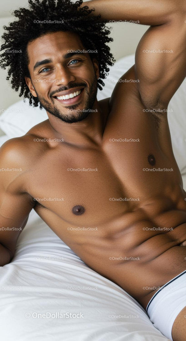 Smiling man relaxing shirtless on white bed