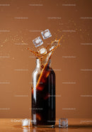 Glass bottle with cola splashing and ice cubes