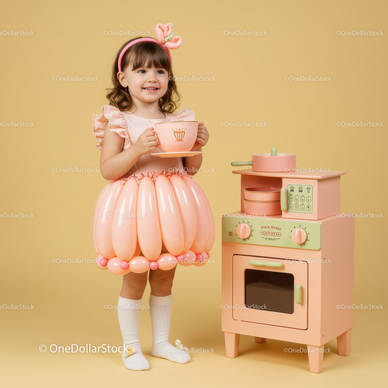 Little girl enjoying tea party with pastel toy kitchen