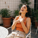 Joyful Woman Laughing in a Bright Outdoor Setting