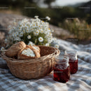 Outdoor Picnic with Fresh Baked Bread and Honey Jars in Sunlight