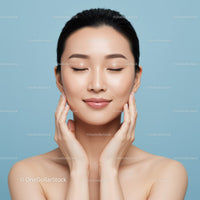 Young Woman with Flawless Skin Relaxing Against Light Blue Background