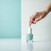 Elegant Woman Hand Applying Light Blue Nail Polish on White Background