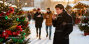 Young man enjoying hot drink at festive winter market
