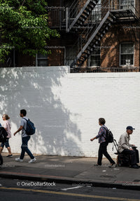 Diverse Pedestrians Walking Along City Sidewalk in Urban Neighborhood