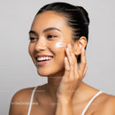 Young Woman Applying Skincare Cream for Radiant Skin