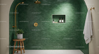 Modern shower space with green tiled wall and gold fixtures