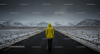 Lonely Traveler in Yellow Jacket on Snow-Covered Road