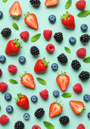 Fresh Mixed Berries and Mint Leaves on Blue Background