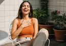 Joyful Woman Laughing Outdoors in Casual Summer Outfit