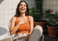 Joyful Woman Laughing Outdoors in Casual Summer Outfit