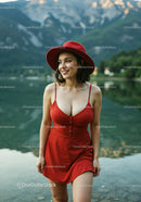 Stylish Woman in Red Dress and Hat Enjoying Lakeside Scene