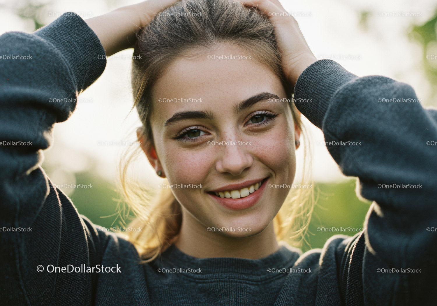 Joyful Young Woman Outdoors Sunlit Nature with Bright Smile