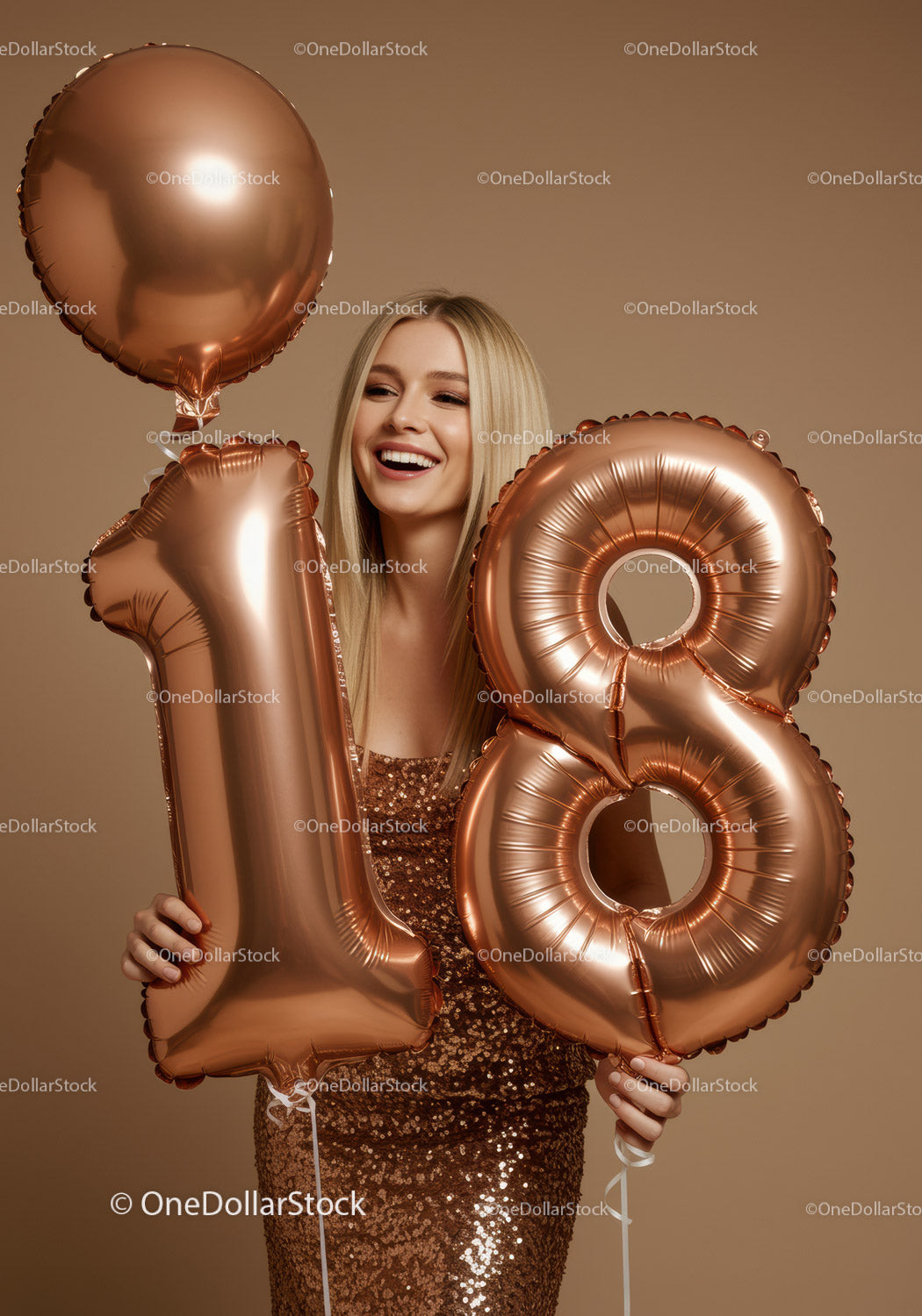 Smiling young woman holding 18th birthday balloons