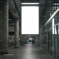 Empty urban corridor with large illuminated billboard