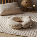 Soft baby pillow and bedding on cozy nursery bed
