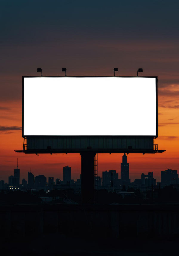 Blank billboard glowing against city skyline at sunset JPG Mockup Image