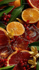 Fresh Sliced Citrus Fruits with Ice and Pomegranate on a Vibrant Background