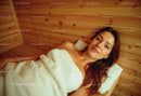 Relaxing Woman Lying on Wooden Bed in Spa or Wellness Center