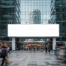 Modern office building entrance with blank billboard