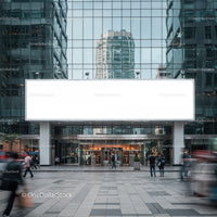 Modern office building entrance with blank billboard