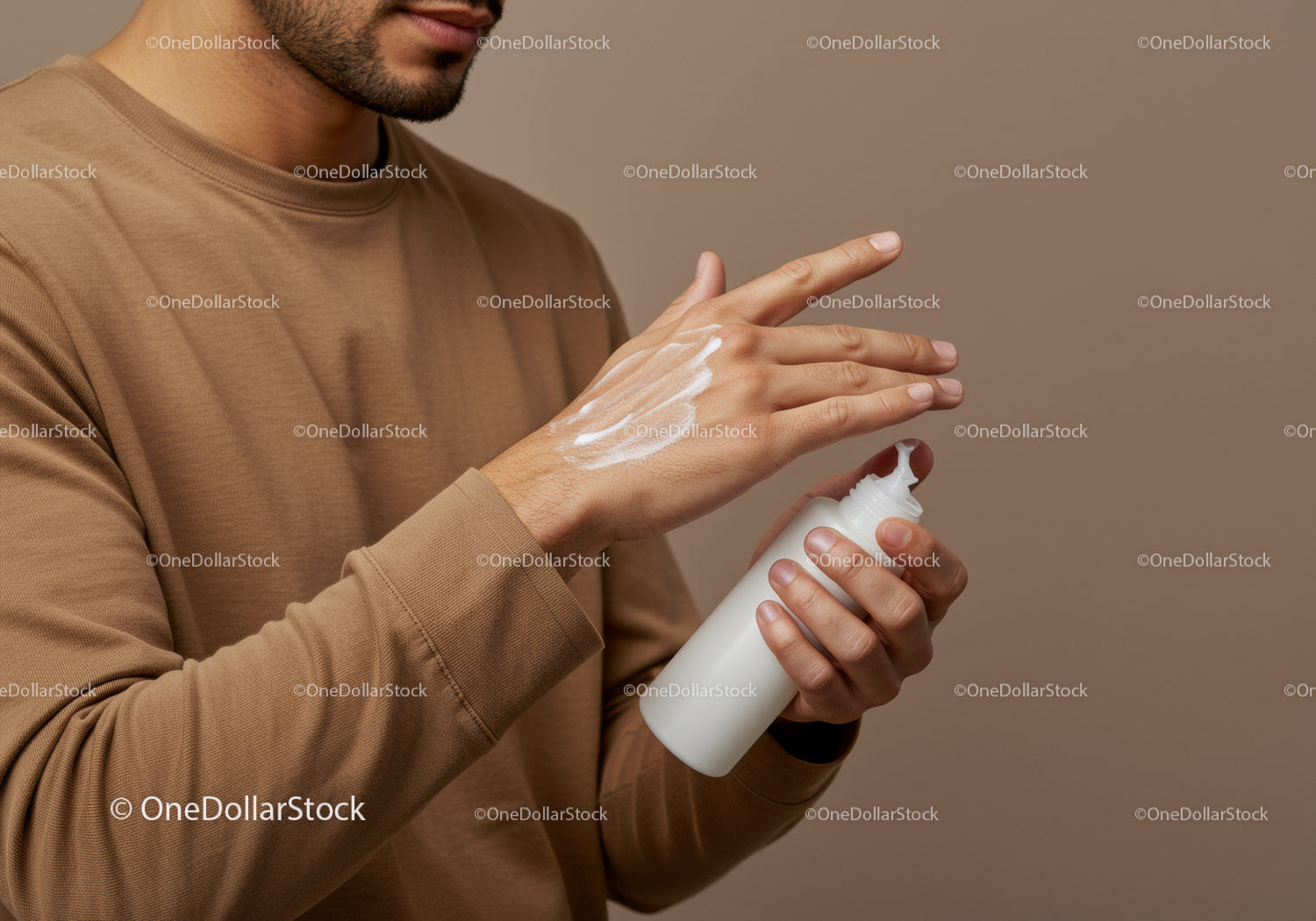 Man Applying Lotion for Hand Care in a Minimalist Setting
